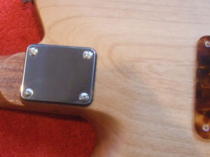 Neckplate fixed in place with slot-headed machine screws