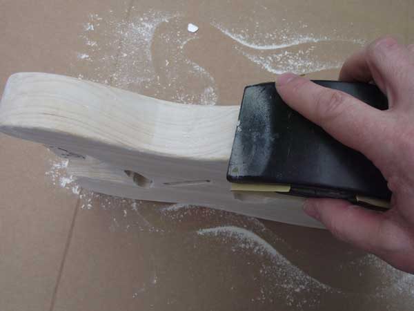 Sanding the grain-filled side smooth