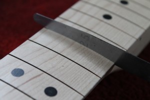 Fret slot width is 25 thousandths of an inch, ideal for my fretwire