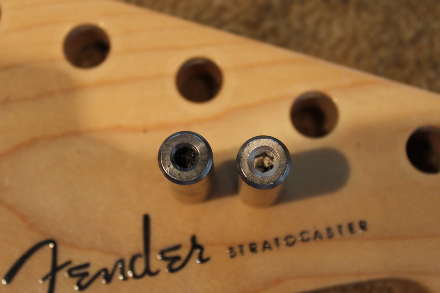 Comparing old and new truss rod nuts, old one is very worn.